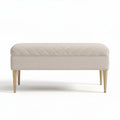 Upholstered ottoman in beige fabric with gold metal legs 80 x 40 x 30cm